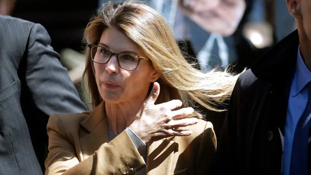 Actress Lori Loughlin reports to prison over college admissions scandal