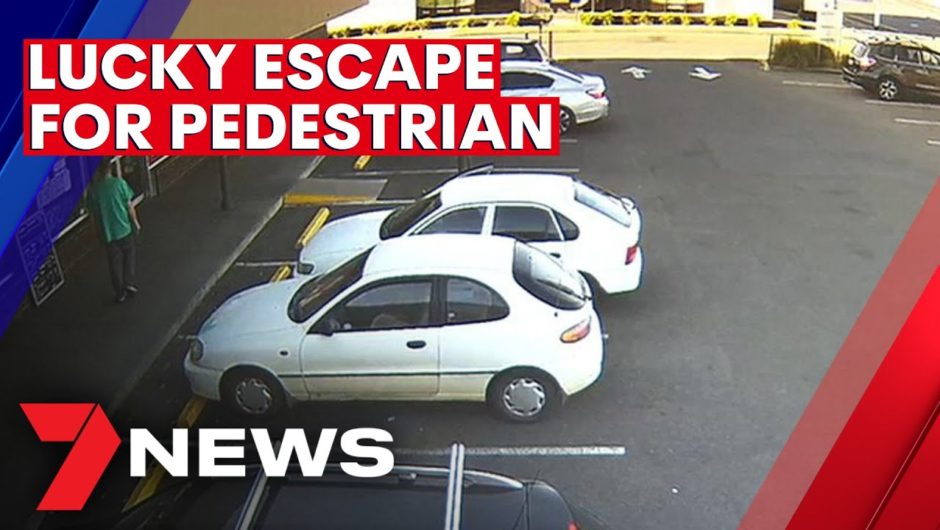 Pedestrian's lucky escape as car ploughs through window and brick wall | 7NEWS